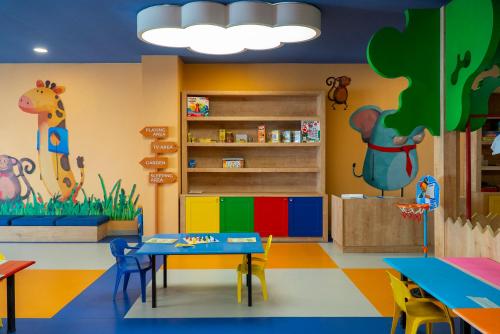 a kindergarten classroom with a table and colorful walls at Adalya Art Side - Ultra All Inclusive in Side
