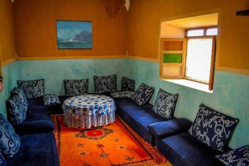 - un salon avec un canapé bleu et une table dans l'établissement دوار ابغاوة ازغيرة تروال سد الوحدة وزان, à Ouazzane