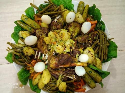 a plate of food with eggs and vegetables on it at دوار ابغاوة ازغيرة تروال سد الوحدة وزان in Ouazzane