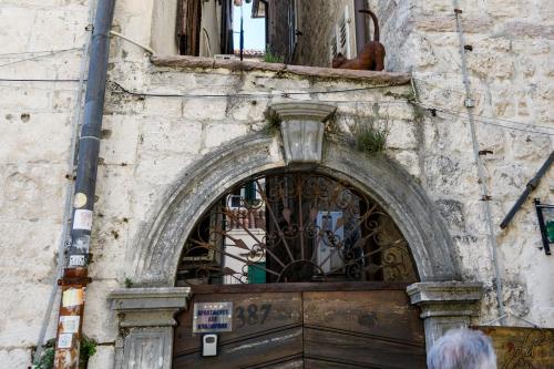 a door to a building with a sign above it at Apartmani Art Karampana in Kotor