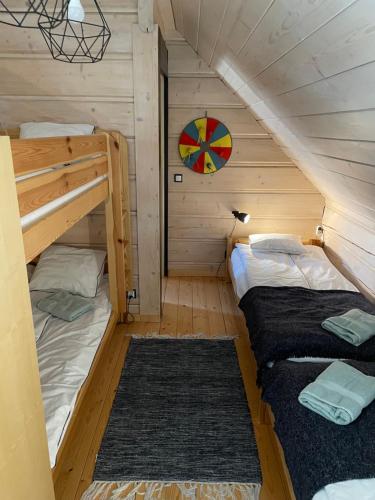a bedroom with two bunk beds in a cabin at Miętusowa Chata pod Babią in Zawoja