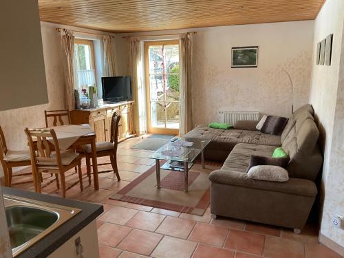 a living room with a couch and a table at Toskanahaus, NJUALMS in Tannheim