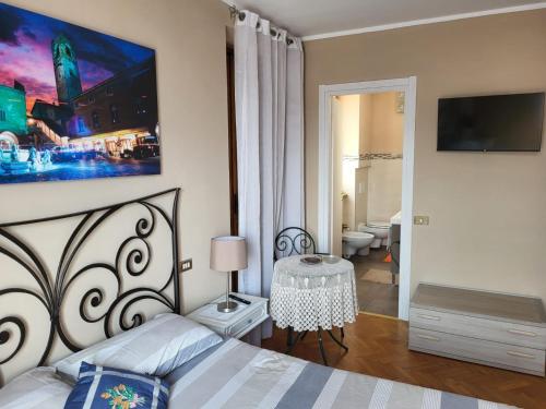 - une chambre avec un lit et une télévision murale dans l'établissement B&B RUFHOUSE, à Lovere