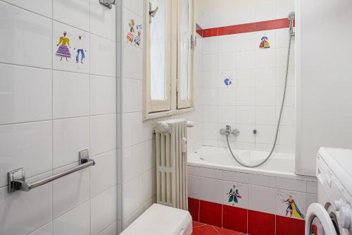 a bathroom with a shower and a toilet and a tub at Brera - San Marco Cozy Apartment in Milan