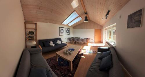 a living room with a couch and a table at Family Friendly Apt A, Garden, 900m LegoHouse, Lalandia, Legoland in Billund