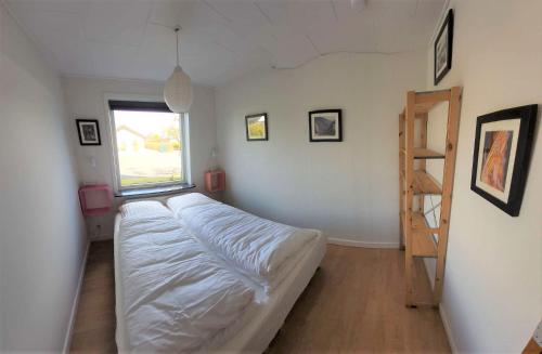 a bedroom with a bed with a ladder in it at Family Friendly Apt A, Garden, 900m LegoHouse, Lalandia, Legoland in Billund