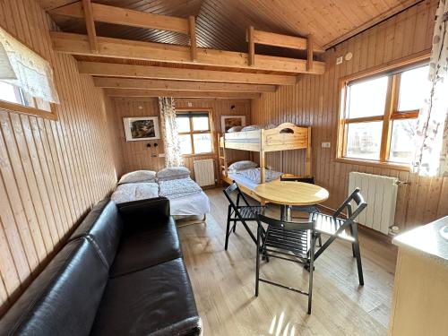 a living room with a couch and a table at Cave Cabins in Hella