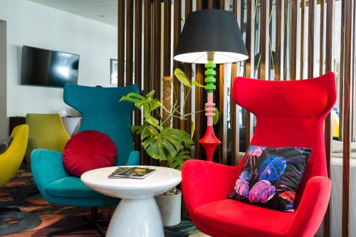 a room with chairs and a lamp and a table at INX Design Hotel in Kraków