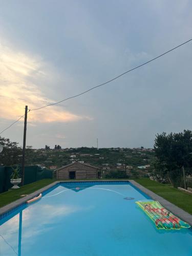 a large blue swimming pool on top of a house at Jobe Guesthouse in Pietermaritzburg