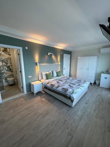 a bedroom with a large bed in a room at Fener Hotel Café & Kahvalti in Cesme