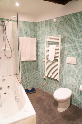 a bathroom with a tub and a toilet and a sink at Martina Guest House in Genova