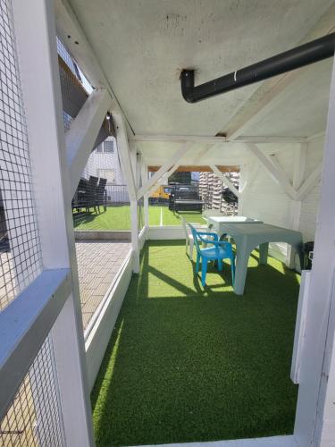 a covered patio with a table and a bench at Schöne Wohnungen in Schwandorf in Schwandorf in Bayern
