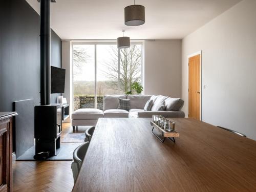 a living room with a couch and a table at Meadow View Cottage in Carnforth