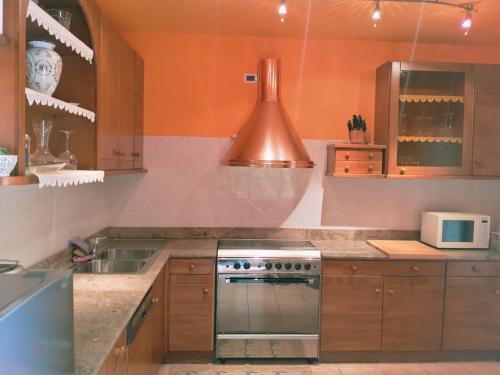 a kitchen with a stove and a sink at Doris' home in Pisogne