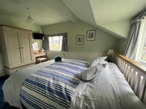 a bedroom with a bed with two pillows on it at Pentre Cerrig Country House in Llanferres