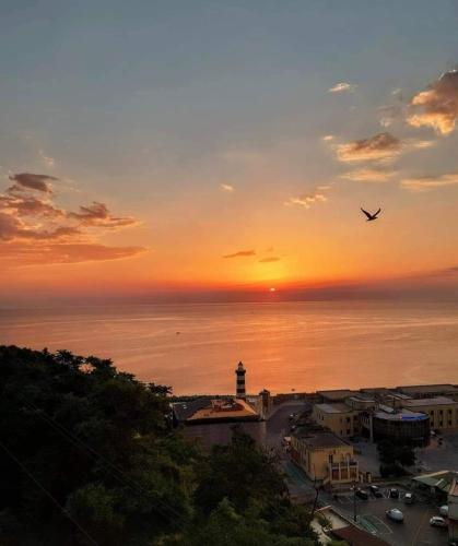 a plane flying over the ocean at sunset at Casa vacanze da Nonna Rosa Ortona in Ortona