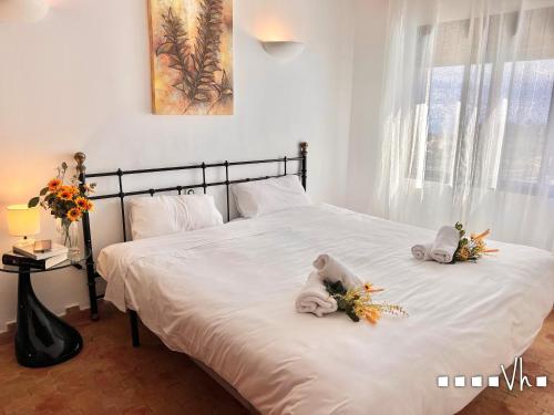 a bedroom with two stuffed animals on a bed at VH CostaBlanca - EL HORIZONTE in Benissa