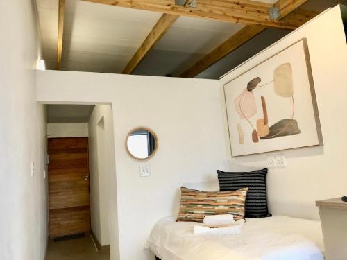 a small bedroom with a bed in a loft at Paarl Views in Paarl