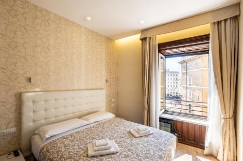 a bedroom with a bed and a large window at MyTinyHome Esquilino in Rome