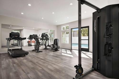 a gym with treadmills and elliptical machines at Ramada by Wyndham Anaheim Convention Center in Anaheim