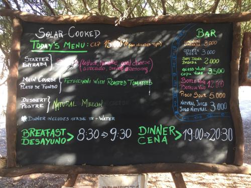 a chalkboard menu for a restaurant on the sidewalk at El Huarango Eco Lodge in La Huaica