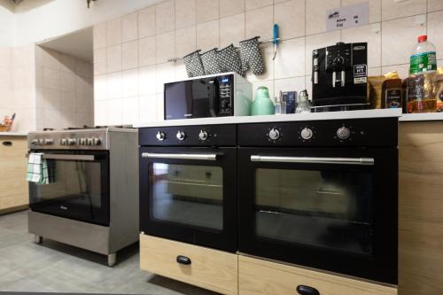 a kitchen with two ovens and a microwave at Chata u kostela in Kořenov