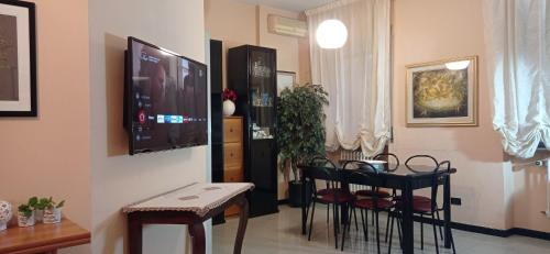 a living room with chairs and a tv on a wall at La casa di Miretta in Chieti