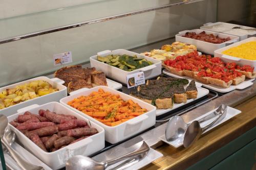 a buffet line with many different types of food at Papadopoli Hotel Venezia - MGallery Collection in Venice