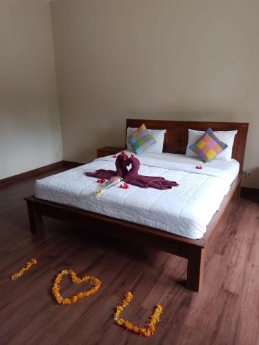 a bedroom with a bed with a stuffed animal on it at Nami House in Ubud