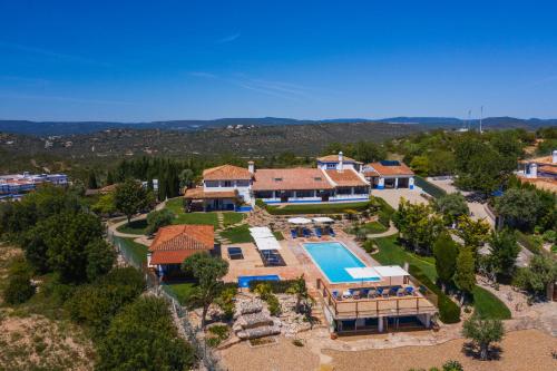 an aerial view of a house with a swimming pool at Shantivillas Malhão in Azinhal