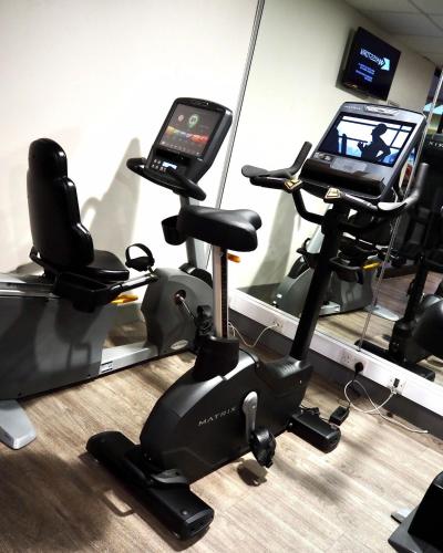 a gym with a cell phone on a exercise bike at Holiday Inn Telford Ironbridge by IHG in Telford