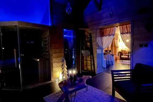 a living room with a couch and a table at night at Les Sources d'Hon - Gîte & Espace wellness in Hon-Hergies