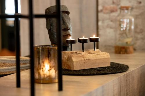 a group of candles sitting on top of a table at Hôtel de la Tour in Melen