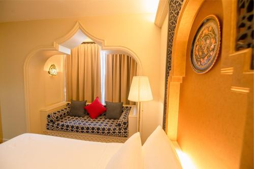 a bedroom with a bed with two red pillows at Amman Unique Hotel in Udon Thani
