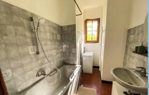a bathroom with a tub and a sink and a shower at Maison centre ville vue mer in Le Lavandou