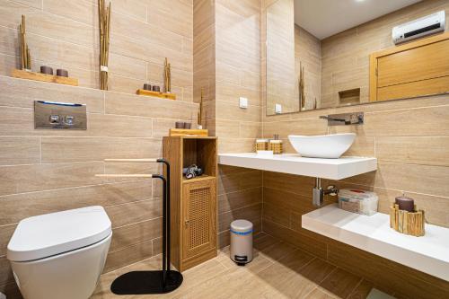 a bathroom with a toilet and a sink at Bellavista Jardim By BeGuest in Albufeira