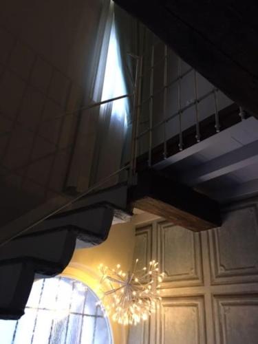 a chandelier hanging from a ceiling with a window at Maisonette in Vigevano