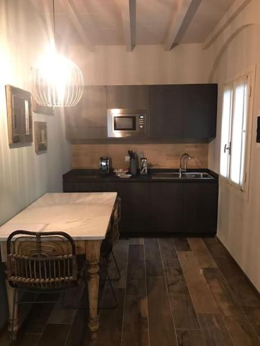 a kitchen with a table and a sink in it at Maisonette in Vigevano