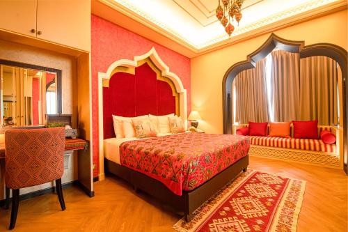 a bedroom with a large bed with a red headboard at Amman Unique Hotel in Udon Thani