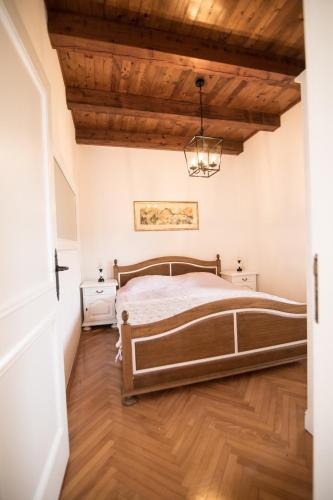 a bedroom with a bed and a wooden ceiling at Villa Ana in Ivanica