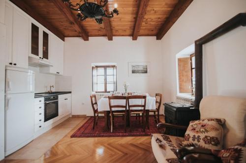 a kitchen with a table and chairs in a room at Villa Ana in Ivanica