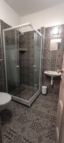 a bathroom with a shower and a sink at Natura Panzió Szilvásvárad in Szilvásvárad