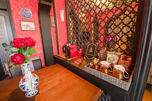 a room with a table with a vase on it at Amman Unique Hotel in Udon Thani