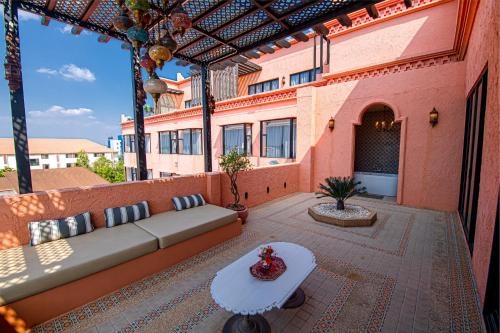 an outdoor patio with a couch and a table at Amman Unique Hotel in Udon Thani