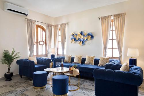 a living room with blue couches and a table at Casa De Monique in Pilerne