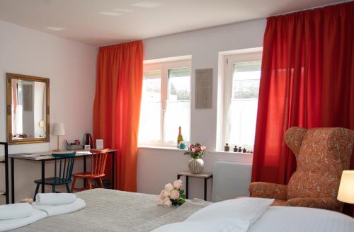 a bedroom with a bed and a chair and a desk at Fani&Rozi B&B in Maribor