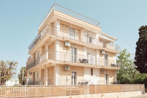 a building with balconies and a fence in front of it at Case Vacanza Torre Canne in Torre Canne