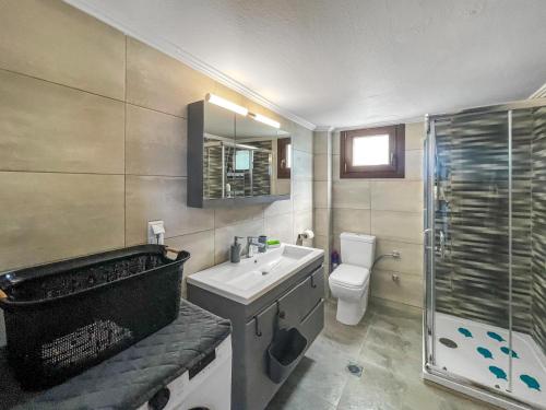 a bathroom with a sink and a toilet and a shower at Luxury apartment in Akti Elias Sithonia in Lagomandra
