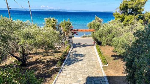a path leading to a beach with the ocean at Luxury apartment in Akti Elias Sithonia in Lagomandra