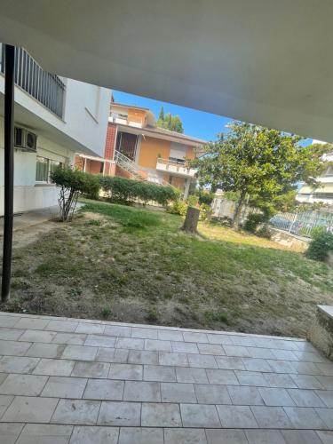 een uitzicht op een tuin met een gebouw en een boom bij Appartamento “Don King” in Ortona